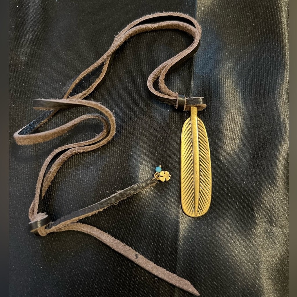 GUC- Lucky Brand brass like feather pendant on leather rope.