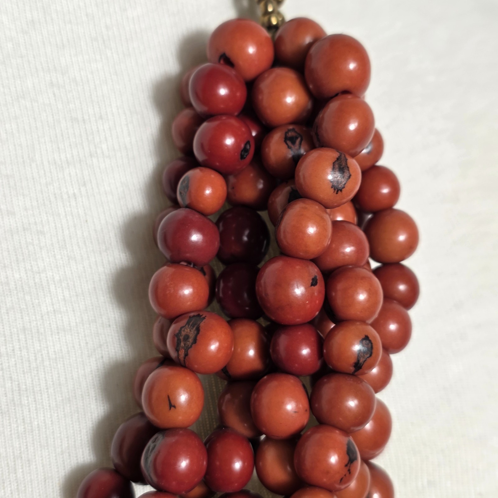 Multi-Strand Dyed Coral Colored Acai Seed Bead Necklace Gold Seed Bead Accents