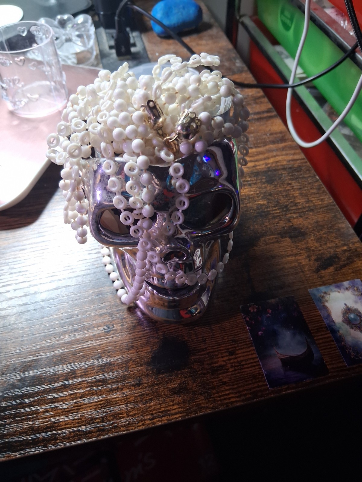 Skull Head With about 6 Pieces Of Jewelry With A White Necklace On Top