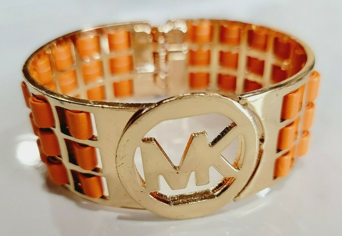 Michael Kors Orange Leather Gold Tone Hinged Cuff Logo Bracelet.