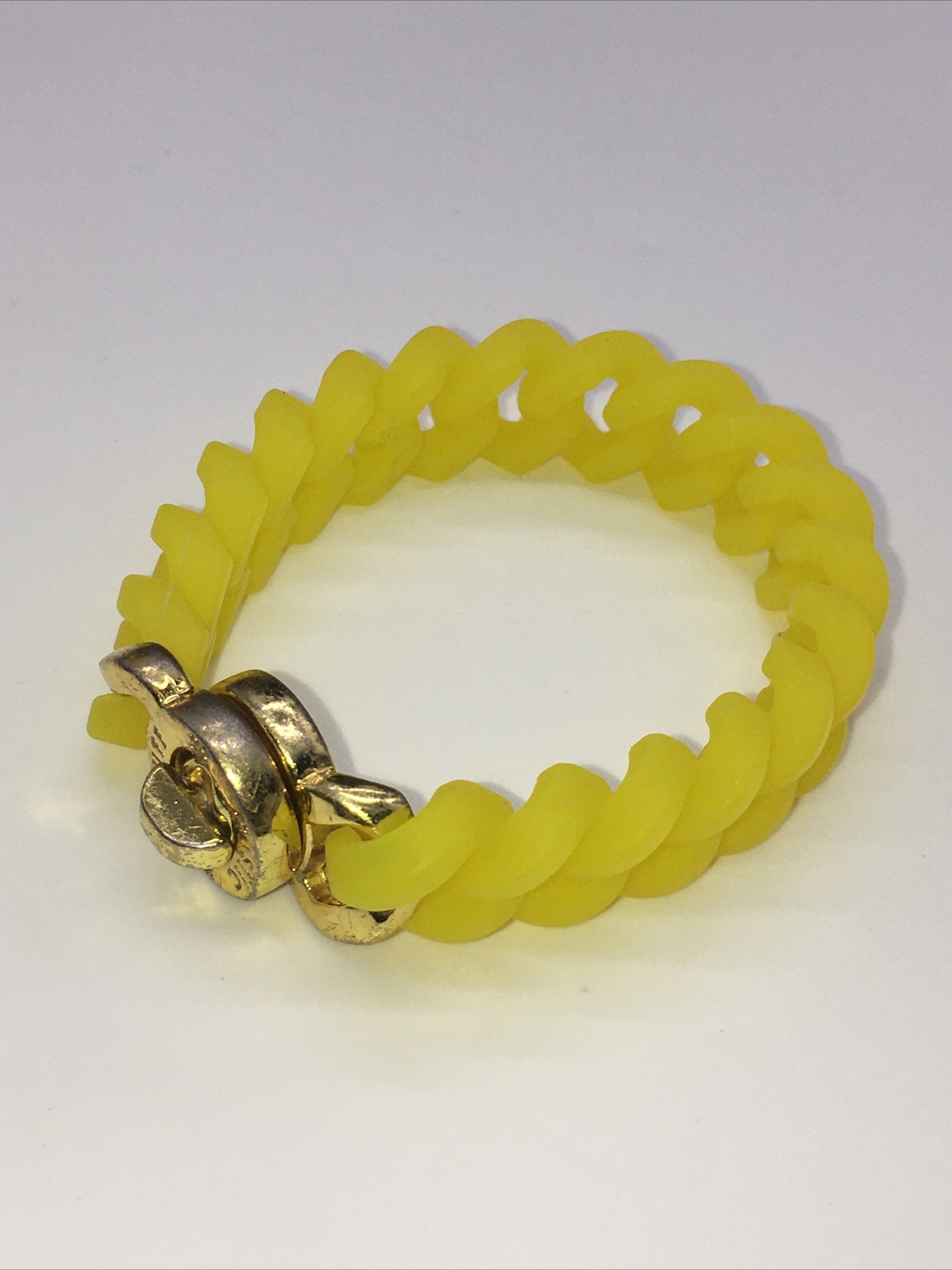 Rustic Cuff Gold Tone Logo Turn Lock Yellow Silicone Stretch Bracelet