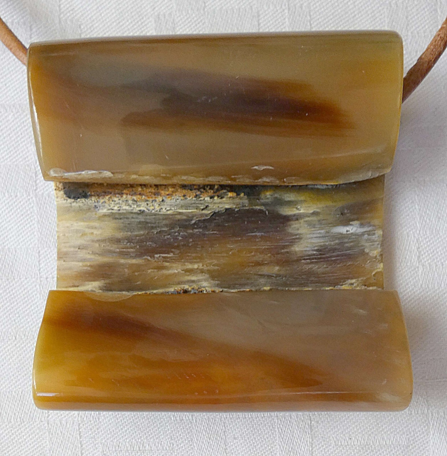 Antique horn necklace with leather cord. Size of pendant: 6.8 x 6.6 cm.