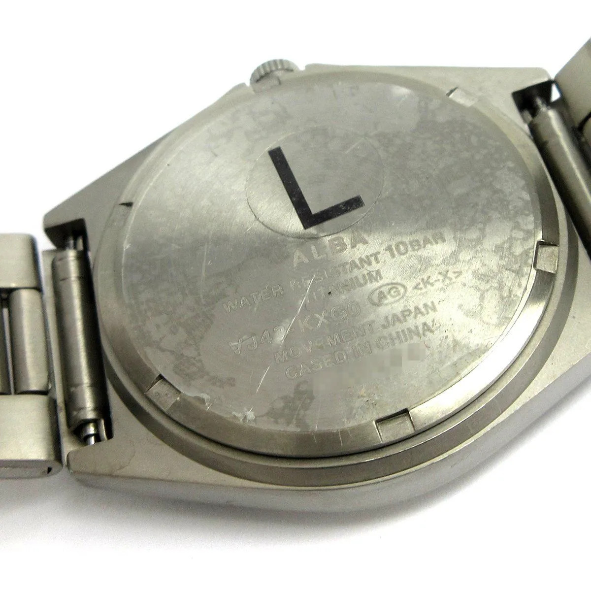 Seiko Alba Men’s Titanium Day-Date Watch with Arabic Numerals and Lumibrite