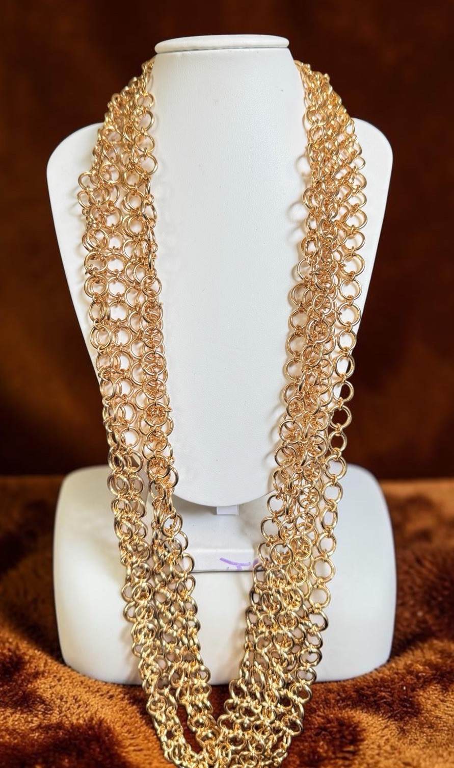 Joan Rivers 72-inch triple-strand goldtone chain necklace.