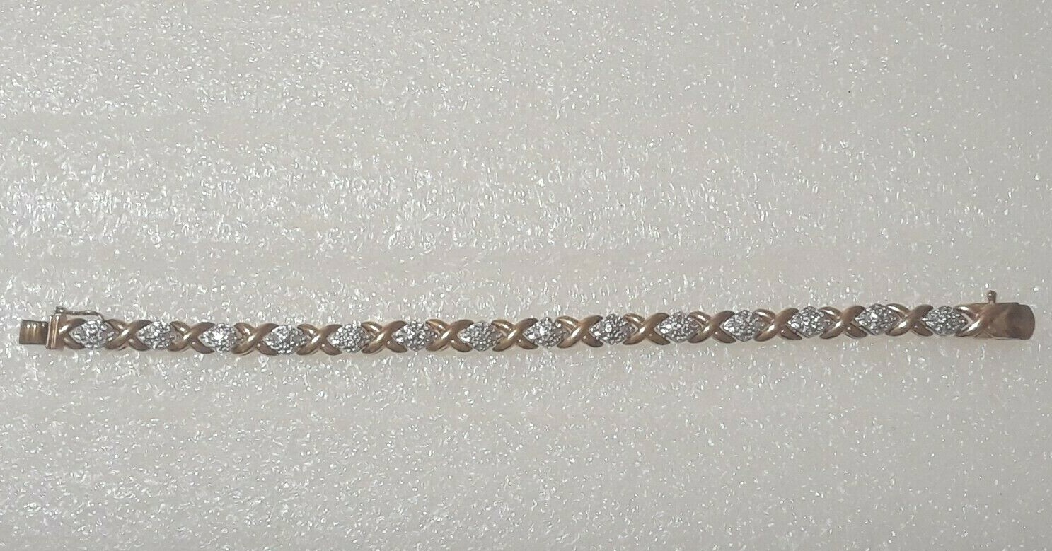 Gold tone bracelet with clear stones and safety lock clasp. 7″ long. Beautiful!