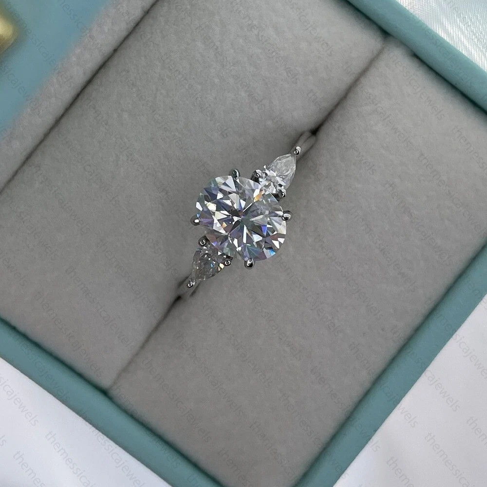 3.10 TCW Oval Cut Moissanite Three Stone Engagement Ring 14K White Gold Plated