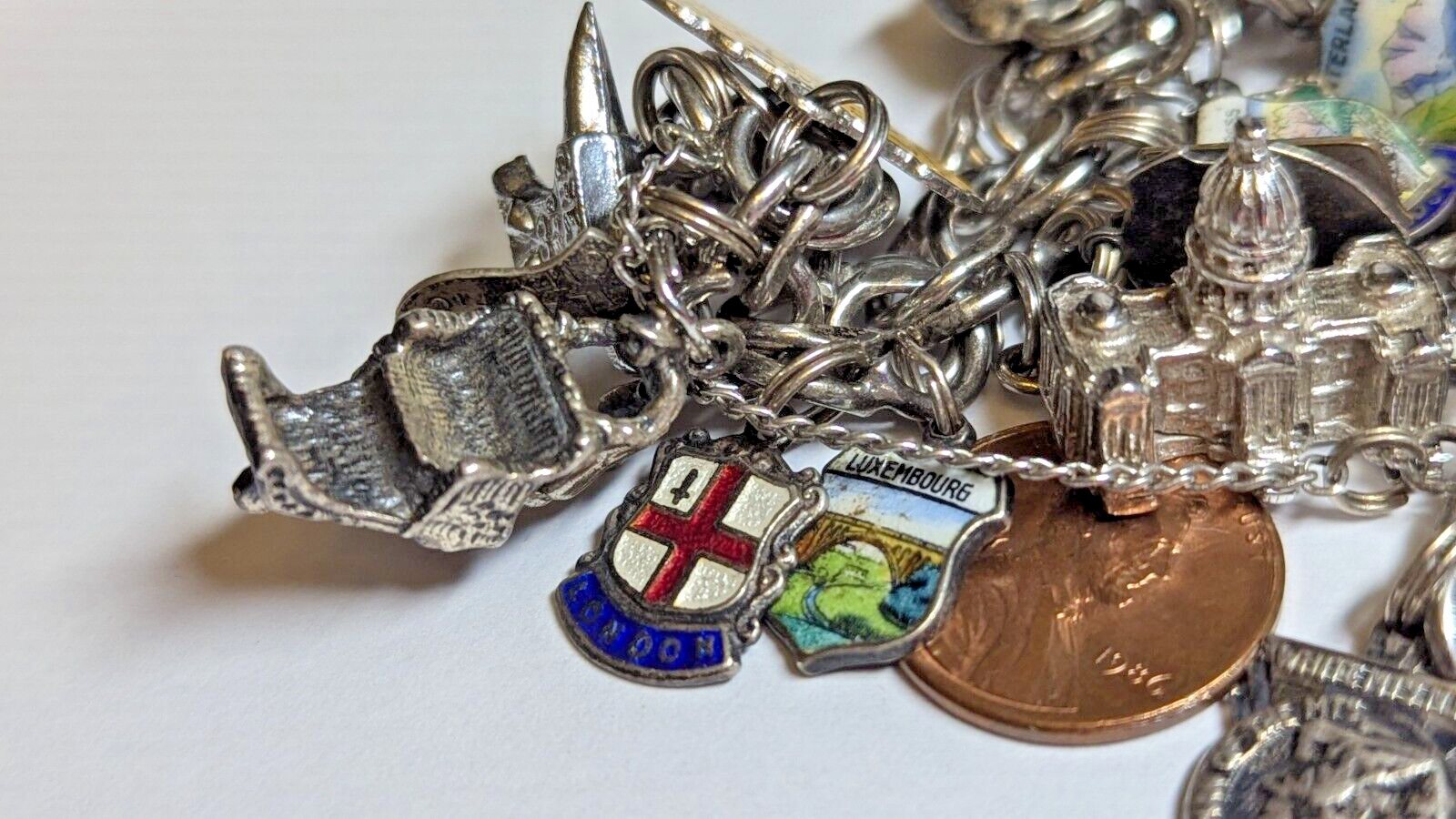 VINTAGE STERLING SILVER CHARM BRACELET WITH ABOUT 35 CHARMS WEIGHS 94.4 GRAMS
