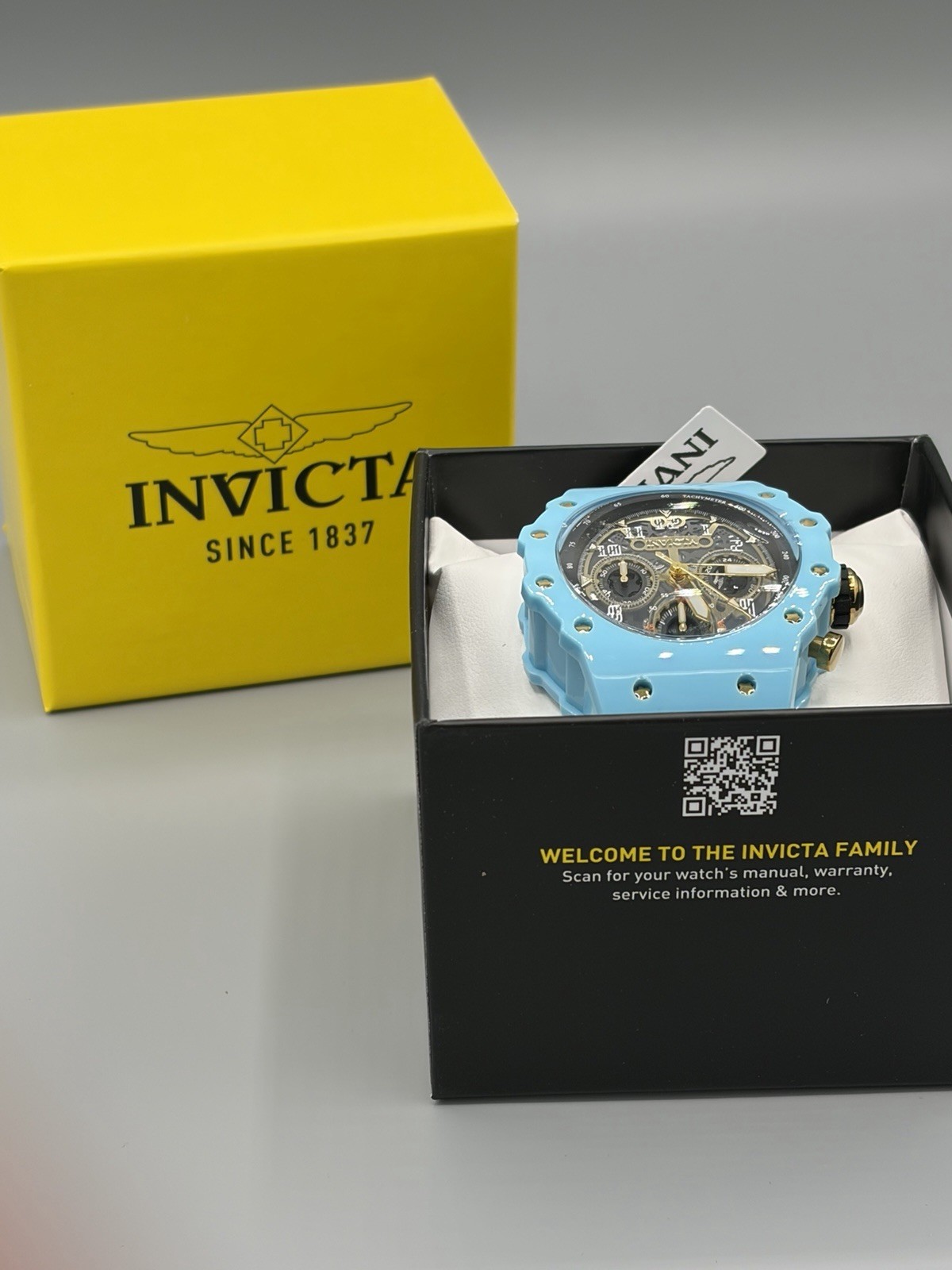 Invicta Racing Quartz Men’s Watch – 69652 – Black & Gold Dial with White Strap