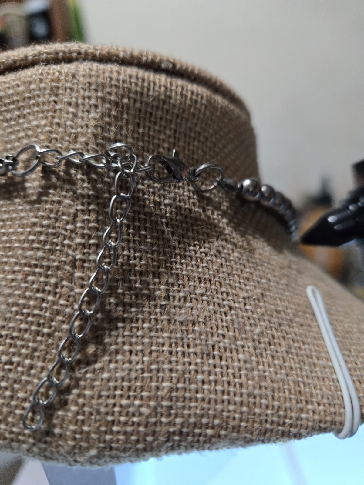 stylish silver-tone statement necklace features textured metal bead tubes…