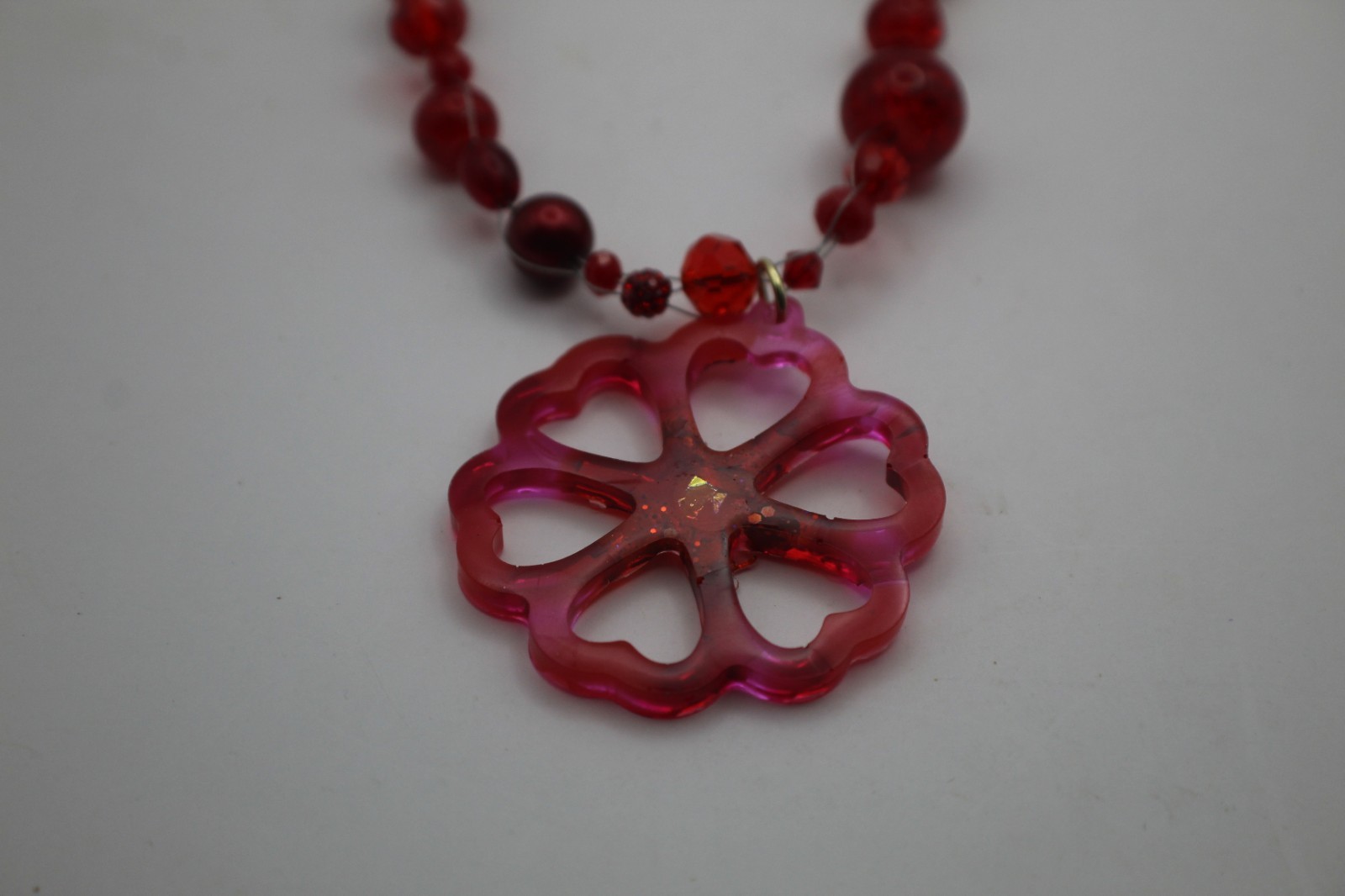 50 Shades Of Red Resin Flower Pendant On A Floating Beaded Necklace