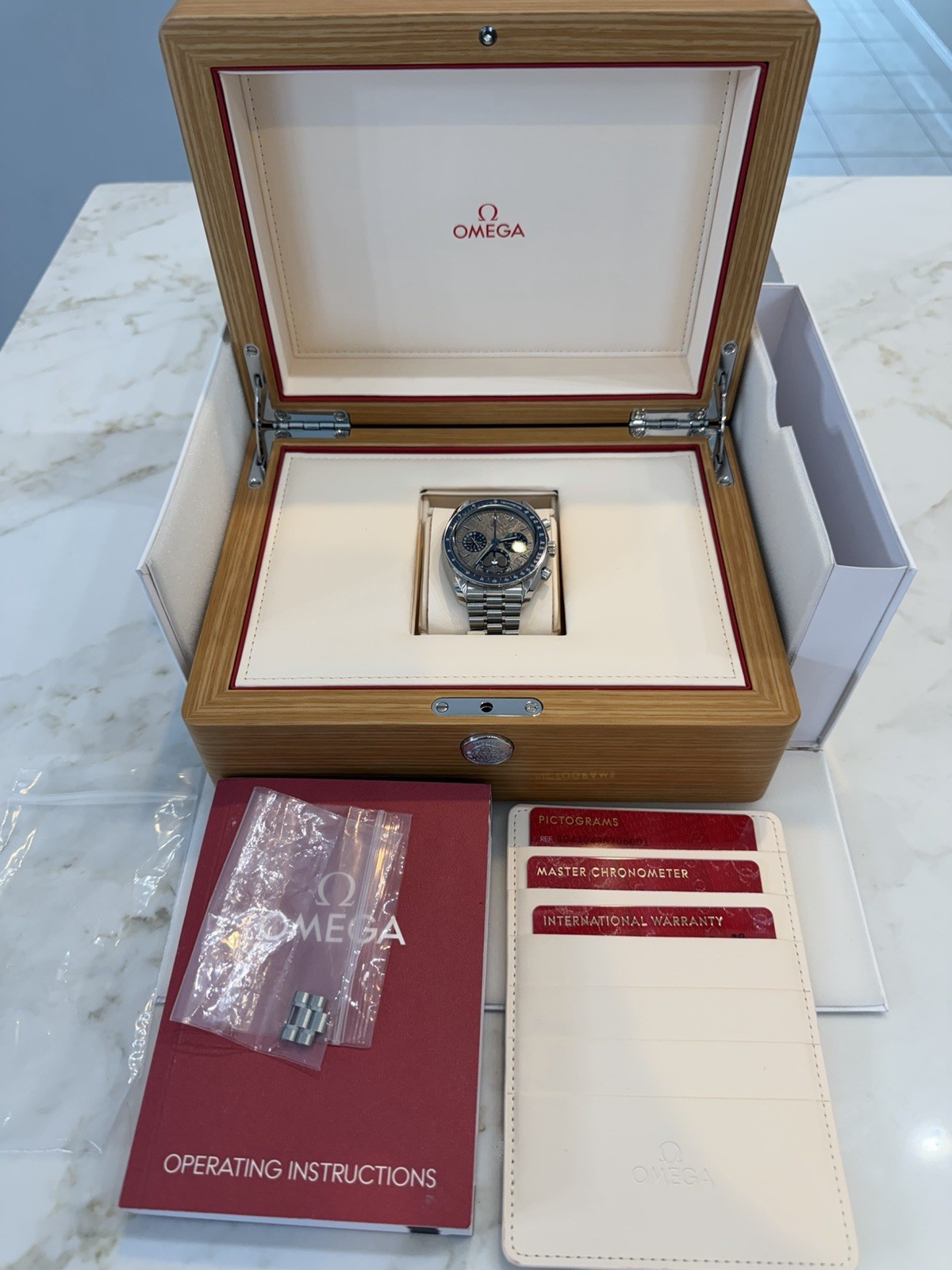 OMEGA Speedmaster 43mm Auto Chronograph Moonphase Meteorite Dial Blue Bezel