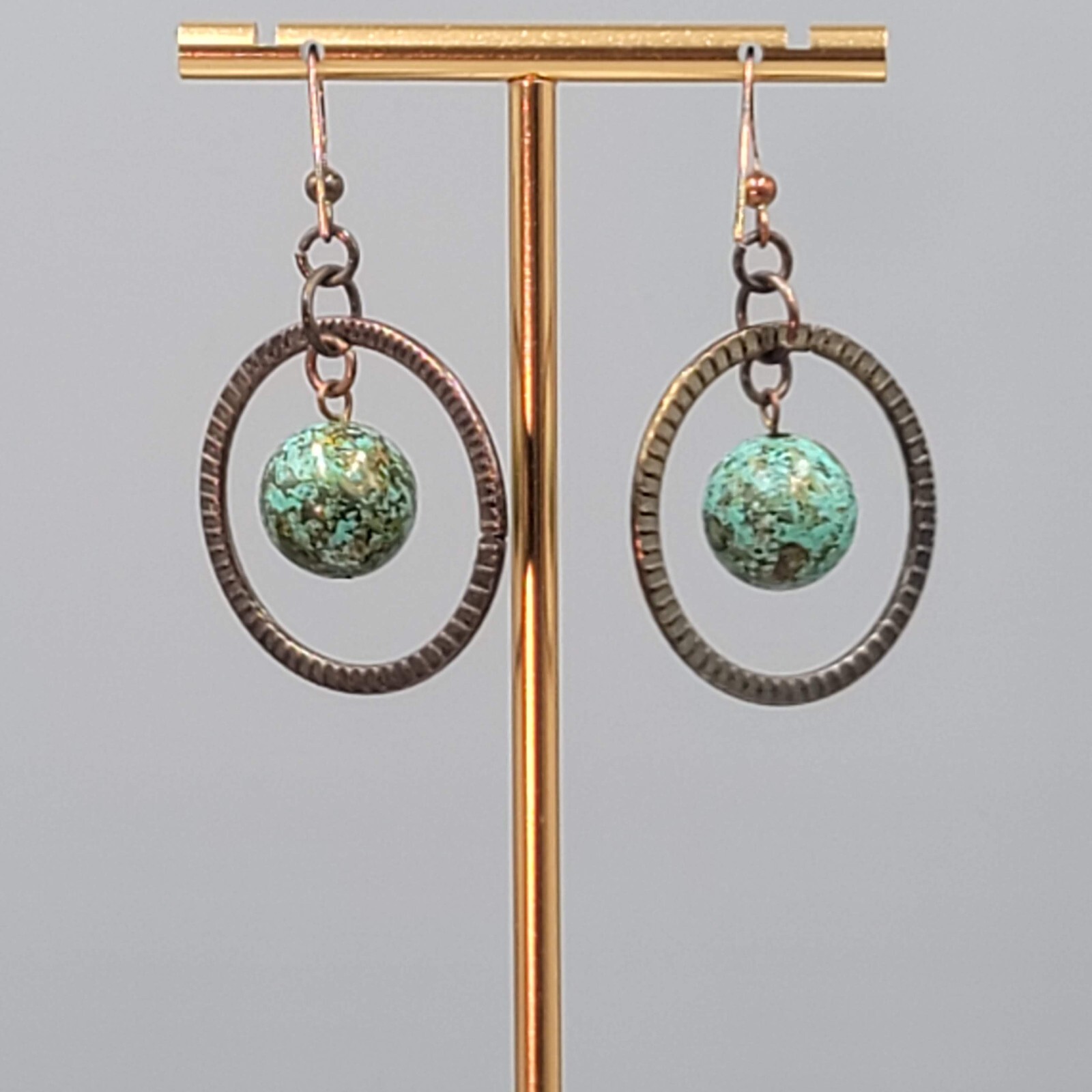 Bronze tone Dangle Pierced Earrings Green Bead Center Dangle 1.5″