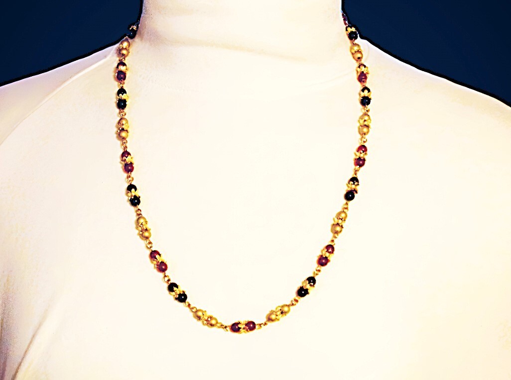 Multi color glass bead necklace with a mix of red, black, and gold colors New
