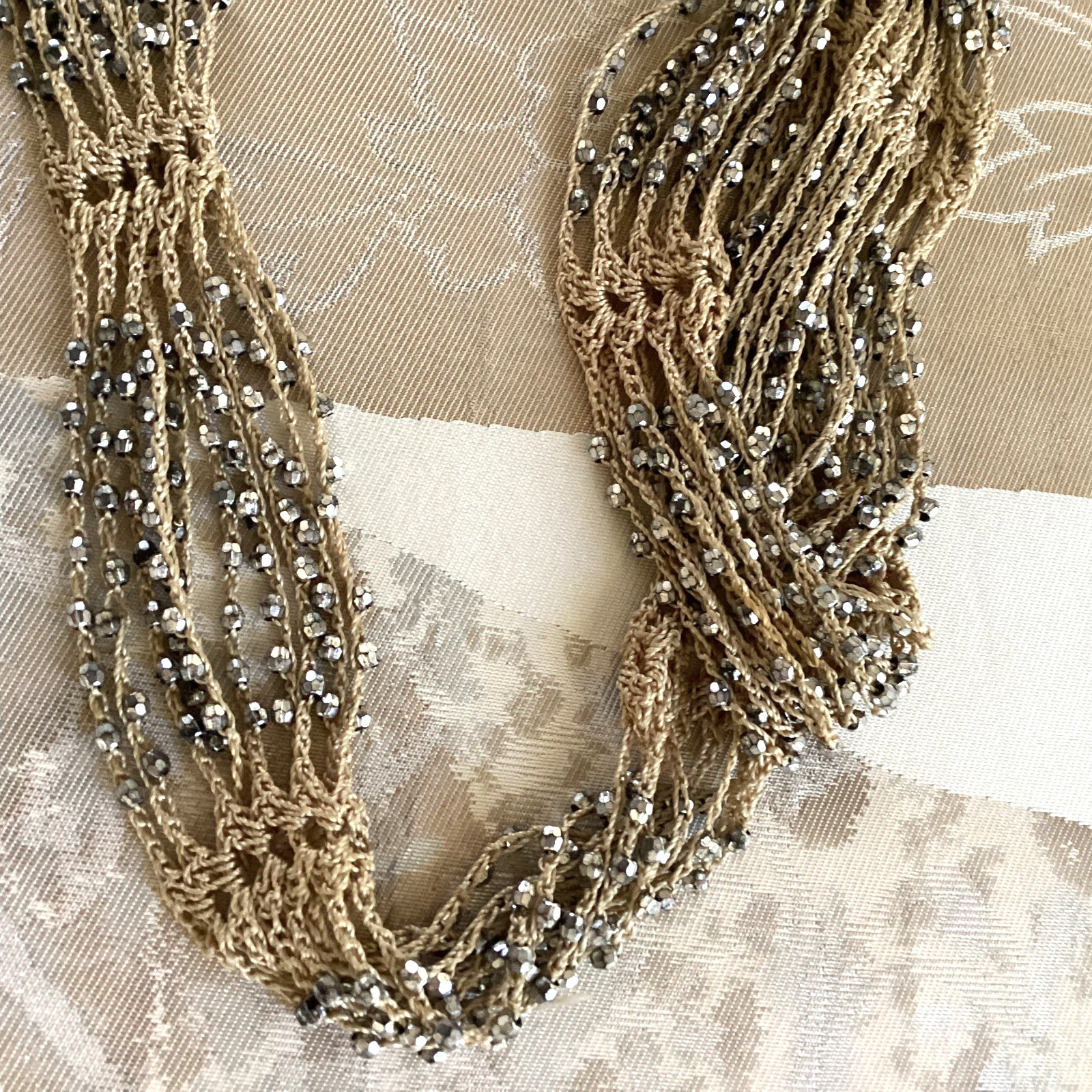 Tan crocheted necklace with silver beads, adjustable, 32 in. long