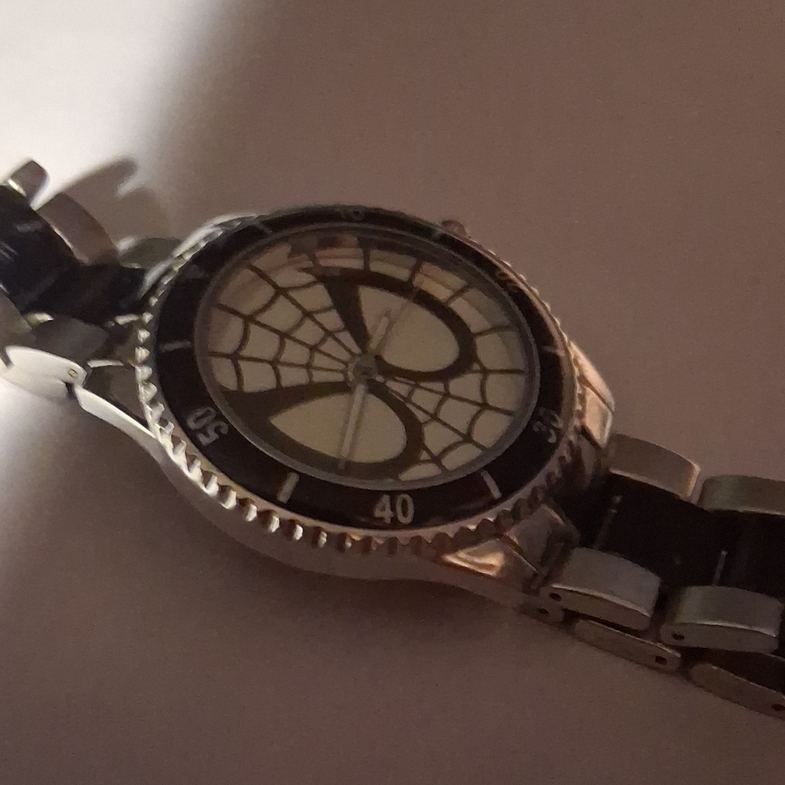 Marvel Men’s Analog Wristwatch Spiderweb Dial Black Fixed Bezel Silver Bracelet
