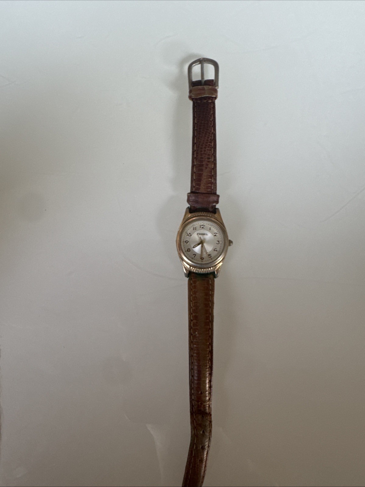 fossil watch bronze face with brown leather band with black inside