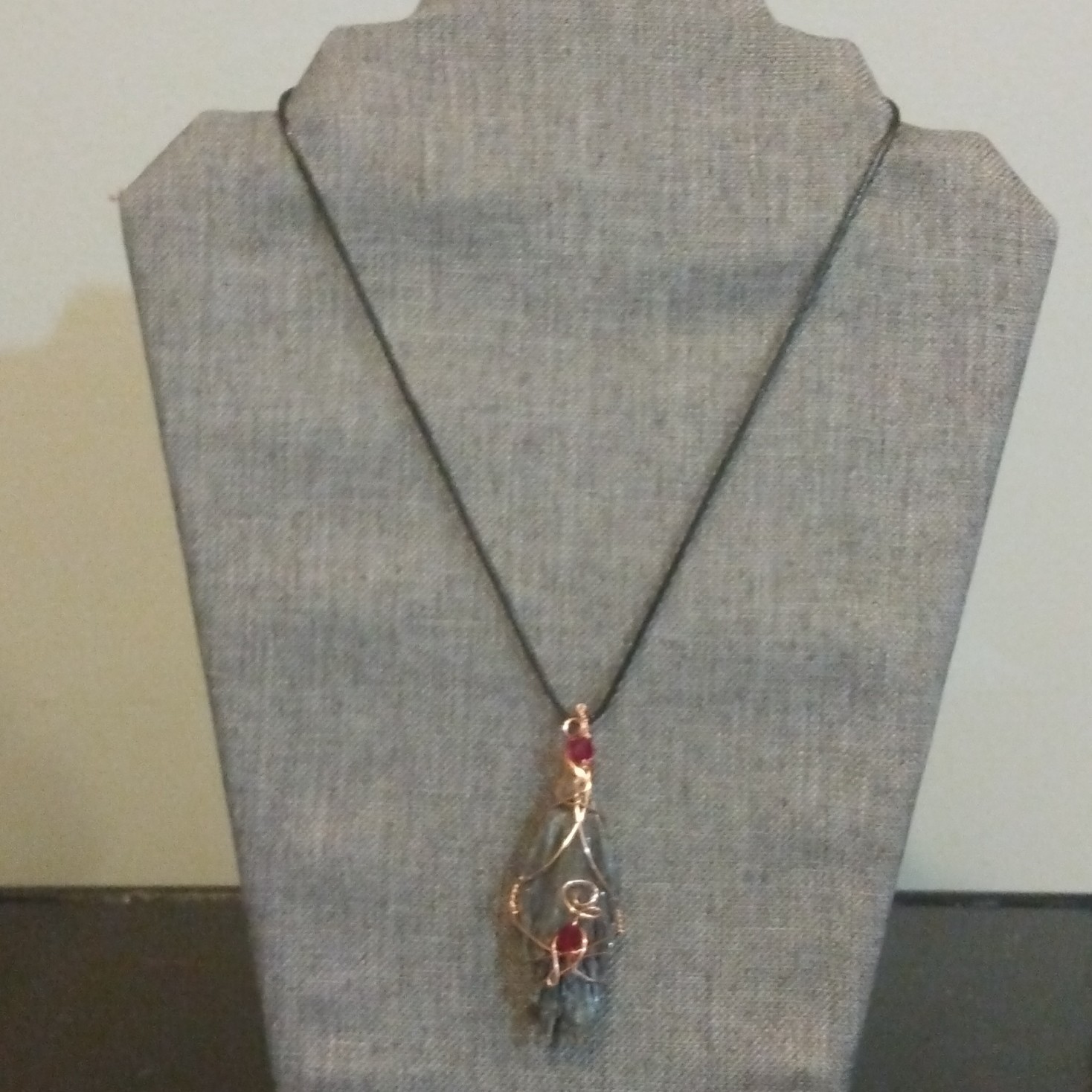 Copper Wire-wrapped Black kyanite Pendant With Ruby Red Czech Crystal Accents.