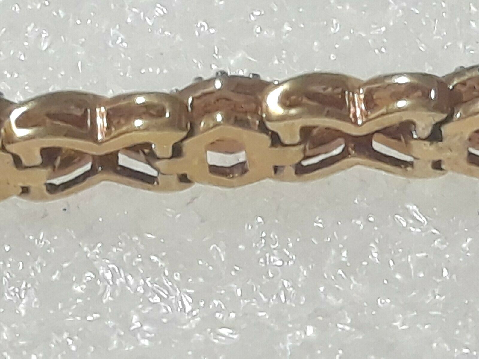 Gold tone bracelet with clear stones and safety lock clasp. 7″ long. Beautiful!