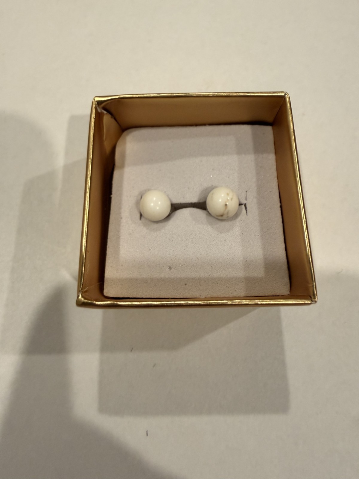 Beautiful 10K gold earrings with smaller round white stone.
