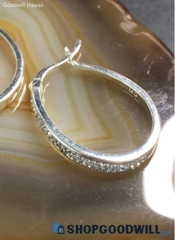 classic oval hoop earrings feature a polished silver-tone finish accented by a