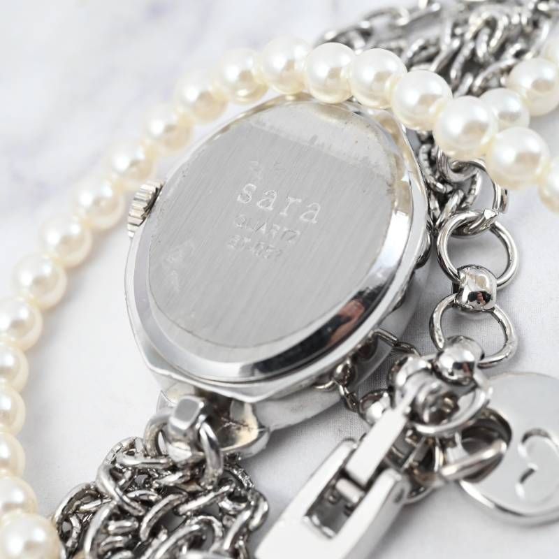 sara ladies’ wristwatch pearl bracelet watch oval shell dial heart motif silver