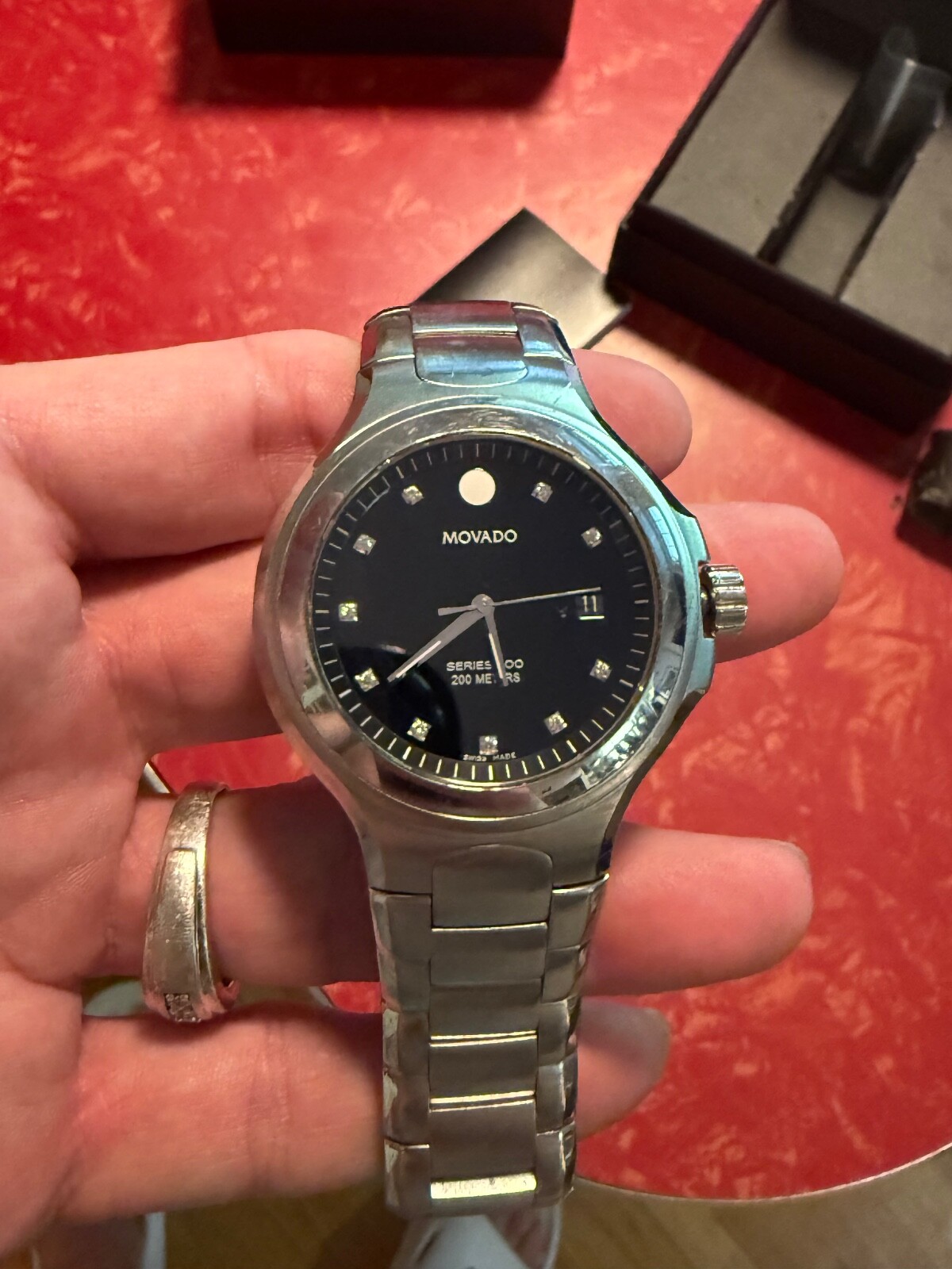 MOVADO 800 SERIES WATCH WITH BLCK BEZEL AND DIAMOND MAKERS – MENS WATCH