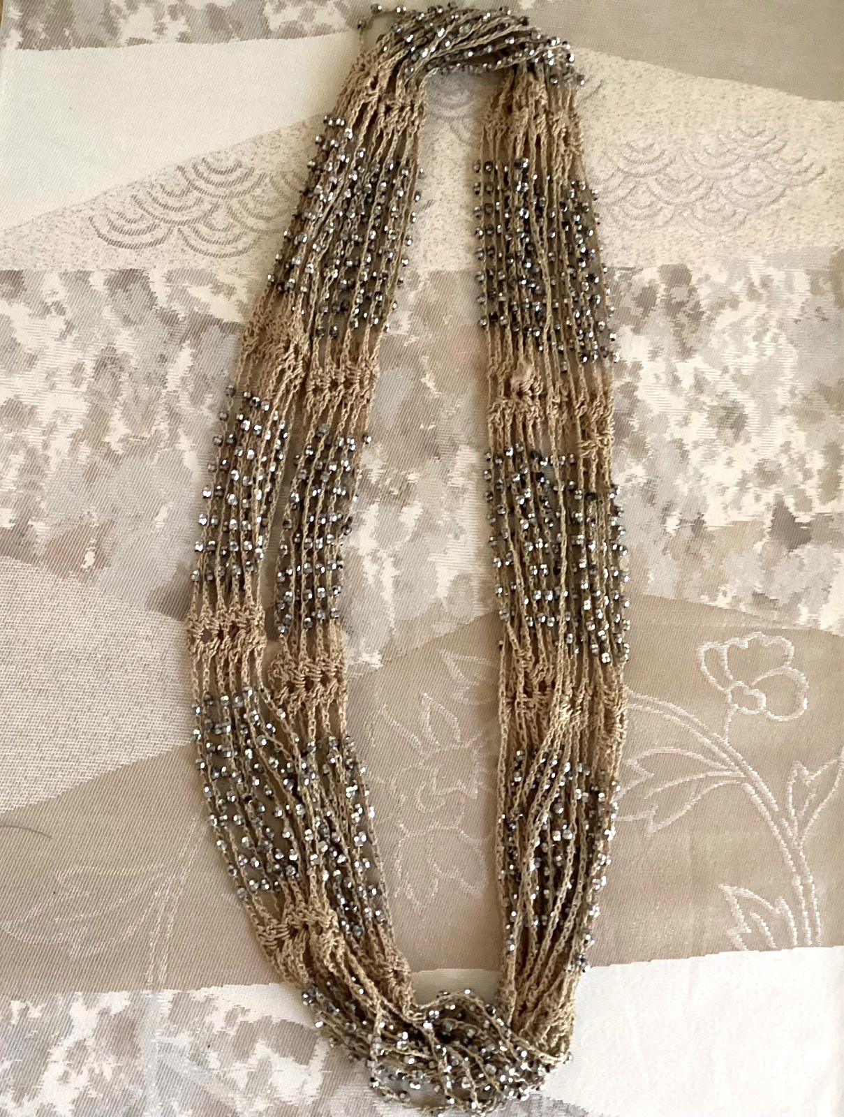 Tan crocheted necklace with silver beads, adjustable, 32 in. long
