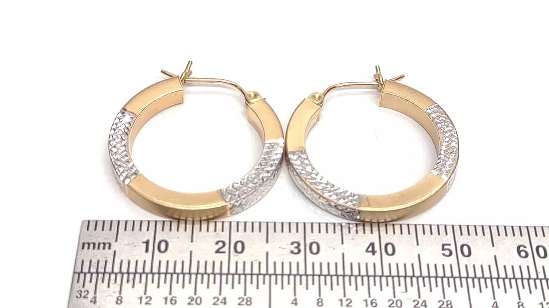 14 karat white and yellow gold hoop earrings. 25mm diameter
