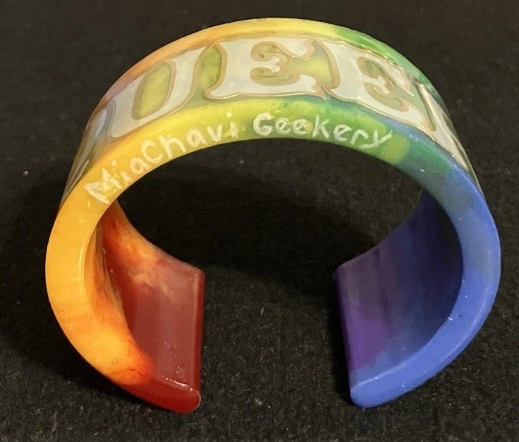 Rainbow “Queer” Cuff Bracelet, Grey And Gold Trim Text, MiaChavi Geekery