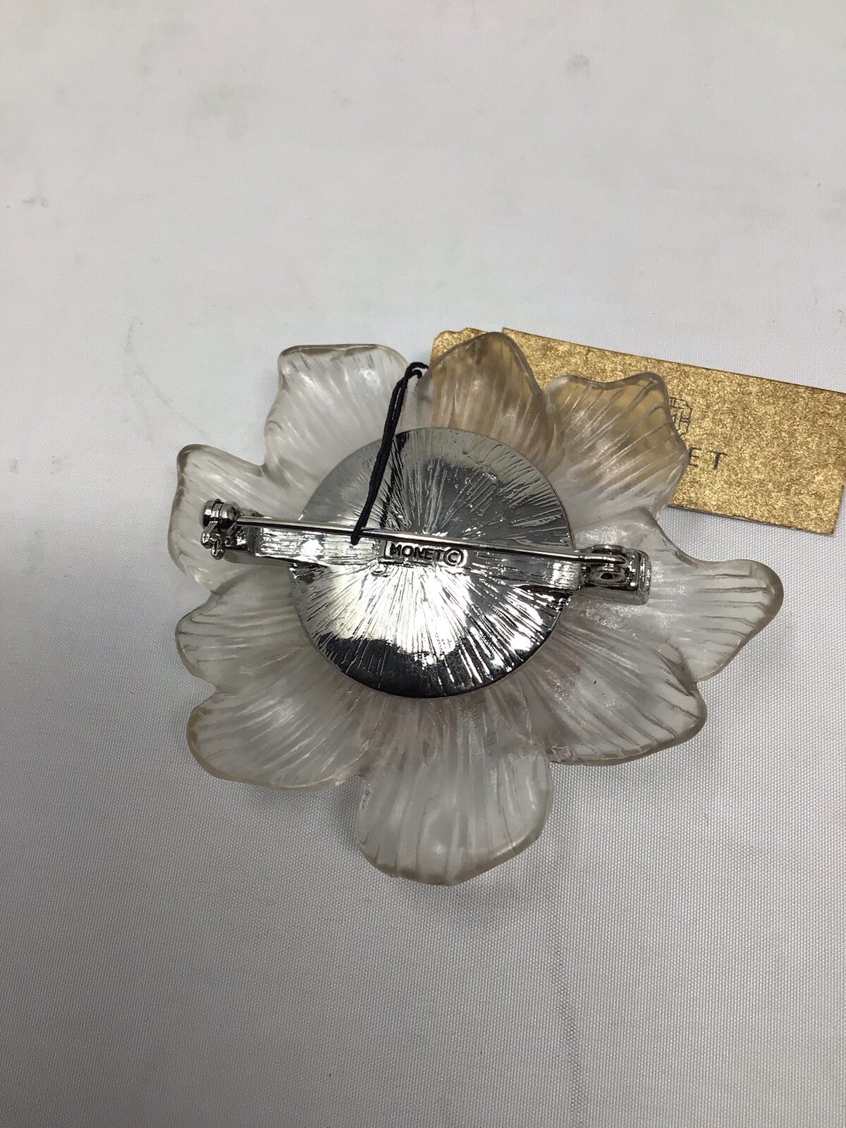 Monet Translucent lucite/plastic molded flower brooch with lavander rhinestone