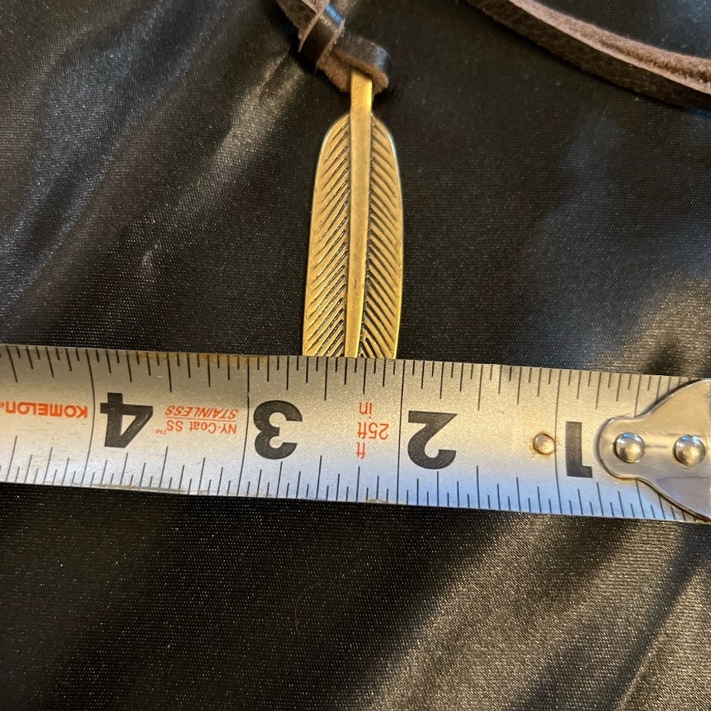 GUC- Lucky Brand brass like feather pendant on leather rope.
