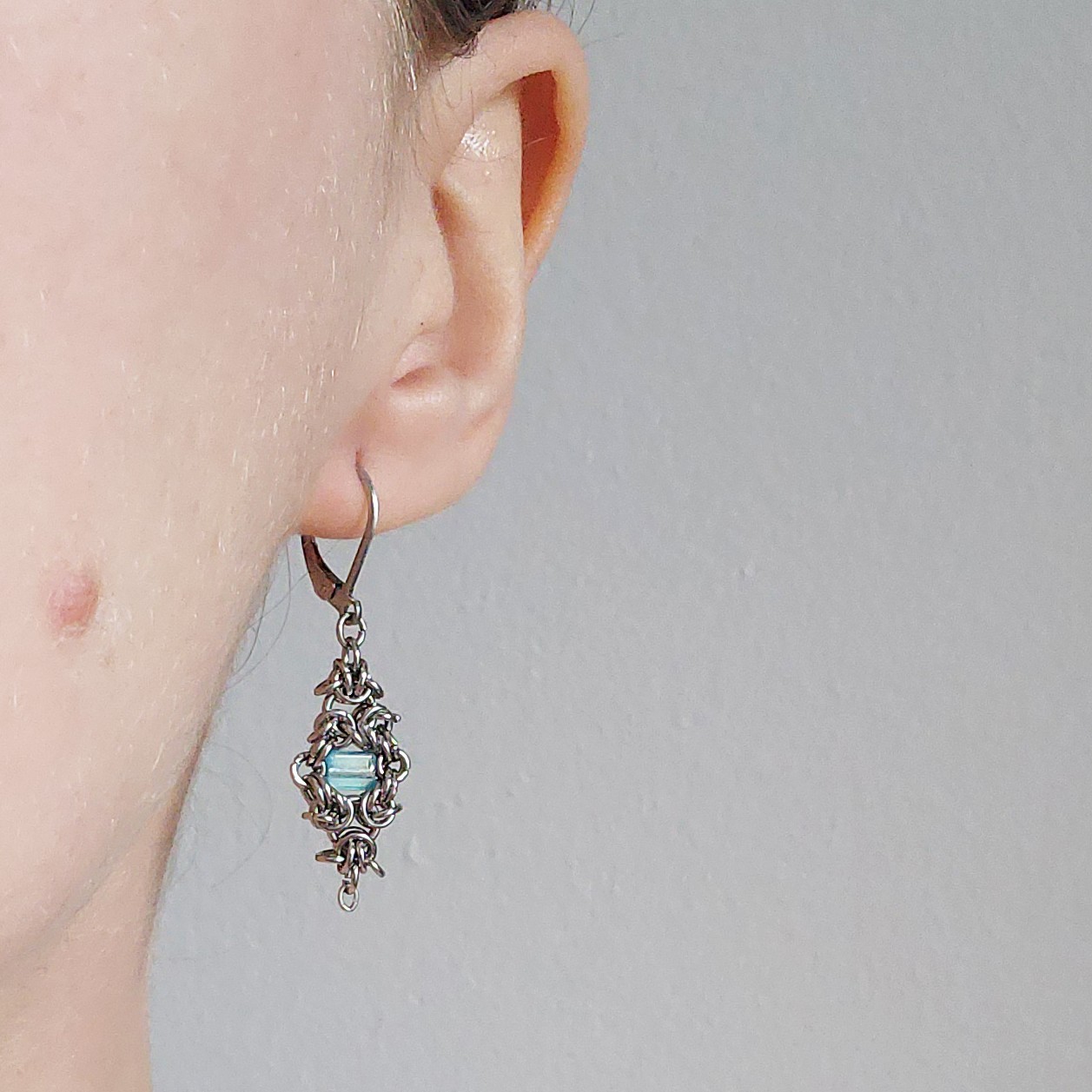 Silver and teal dangly lever back earrings made of stainless steel