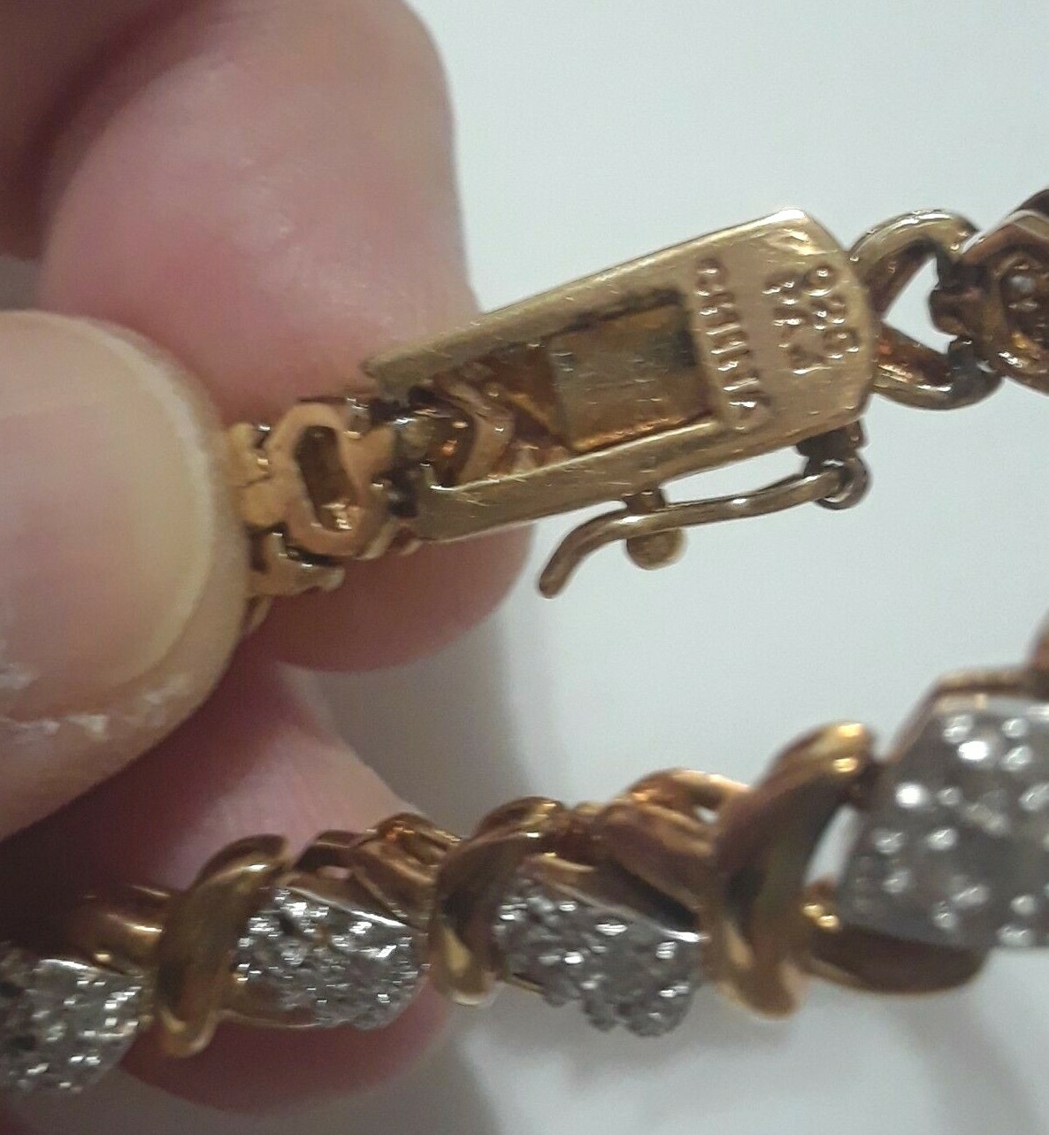 Gold tone bracelet with clear stones and safety lock clasp. 7″ long. Beautiful!