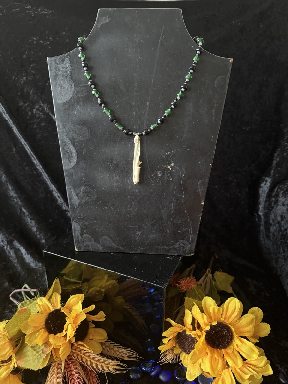 Armadillo leg bone necklace with green, black, gray, and silver glass beads
