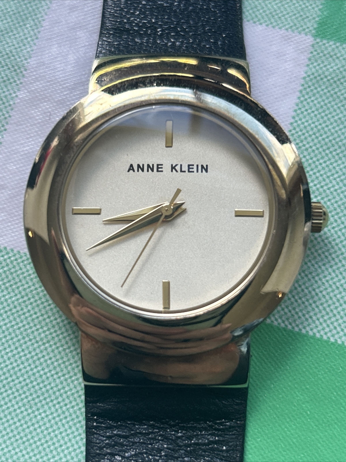 Anne Klein AK/2922 Gold Tone Dial Black Leather Strap Women’s Watch