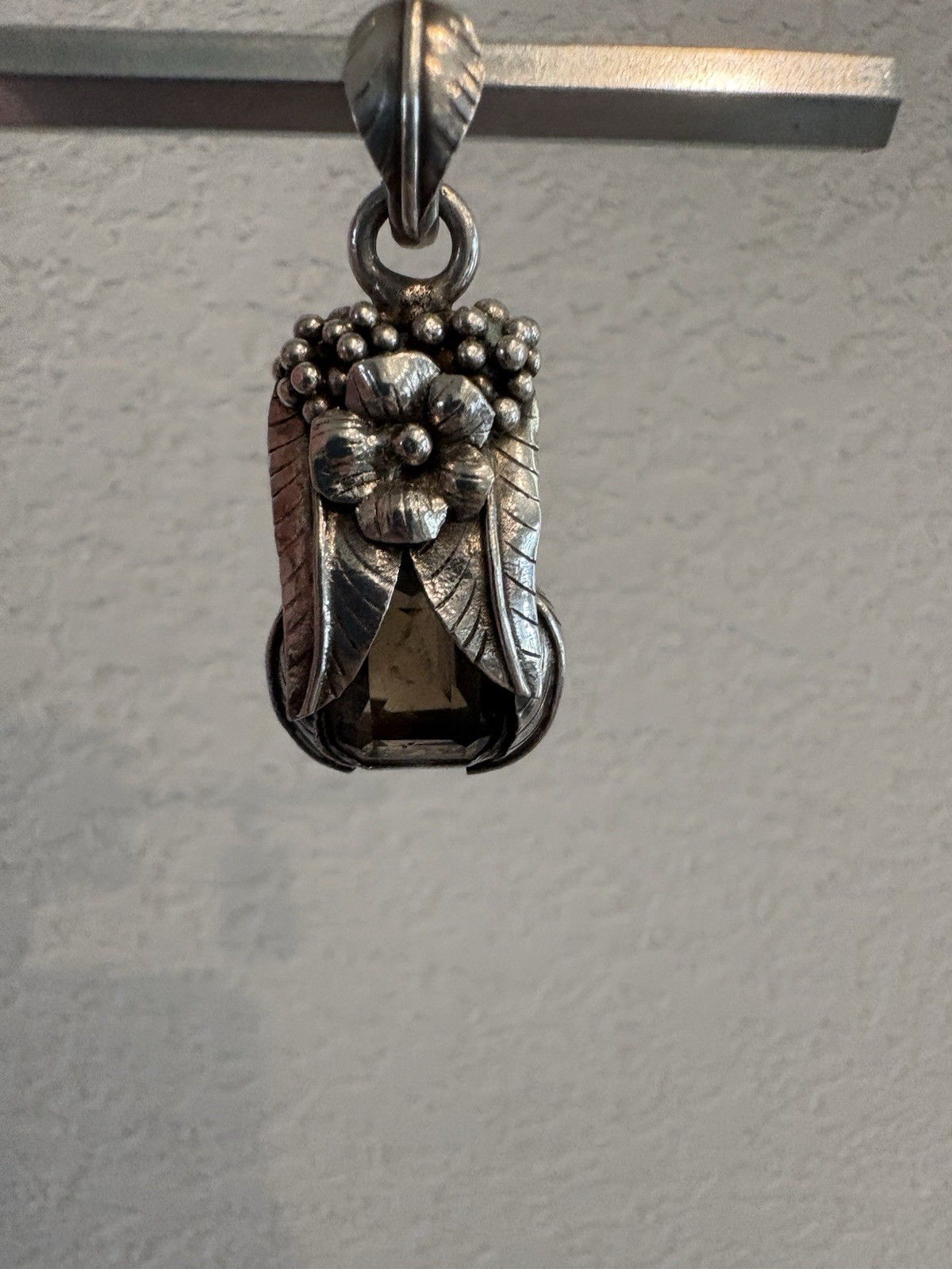 Marked 925 , stone surrounded with silver flower,leaves and berries