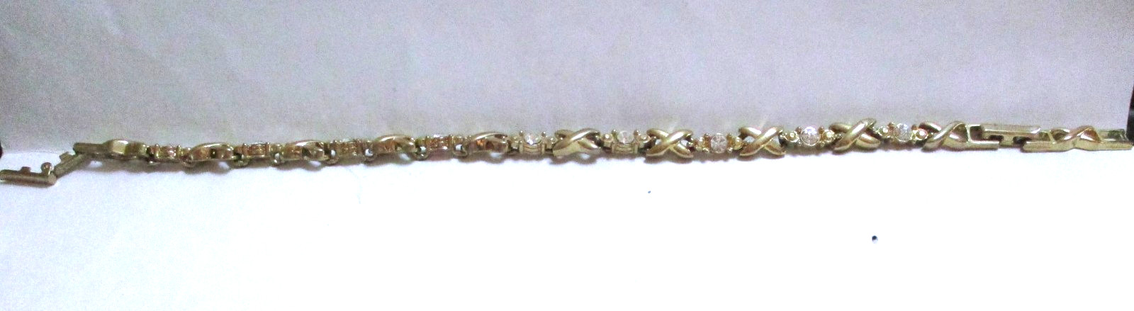 VINTAGE SIGNED AVON RHINESTONE TENNIS BRACELET X’S & O’S, GOLDTONE