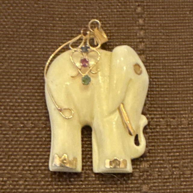 Vintage 14k gold White Elephant hand carved pendant .