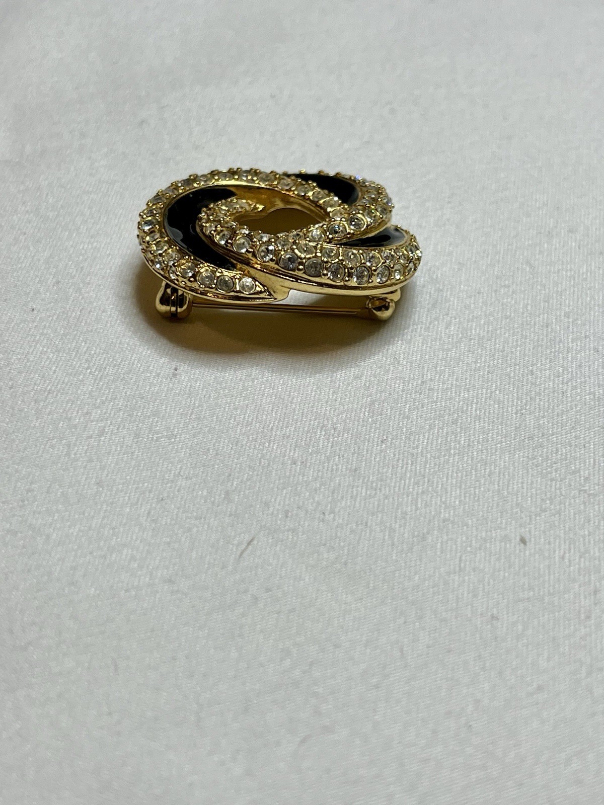 Signed Swarovski Gold Tone Clear Crystal Black Enamel Love Knot Brooch Pin