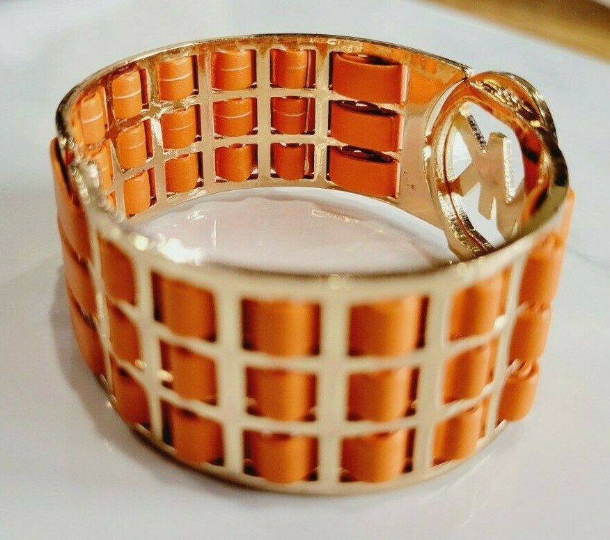 Michael Kors Orange Leather Gold Tone Hinged Cuff Logo Bracelet.
