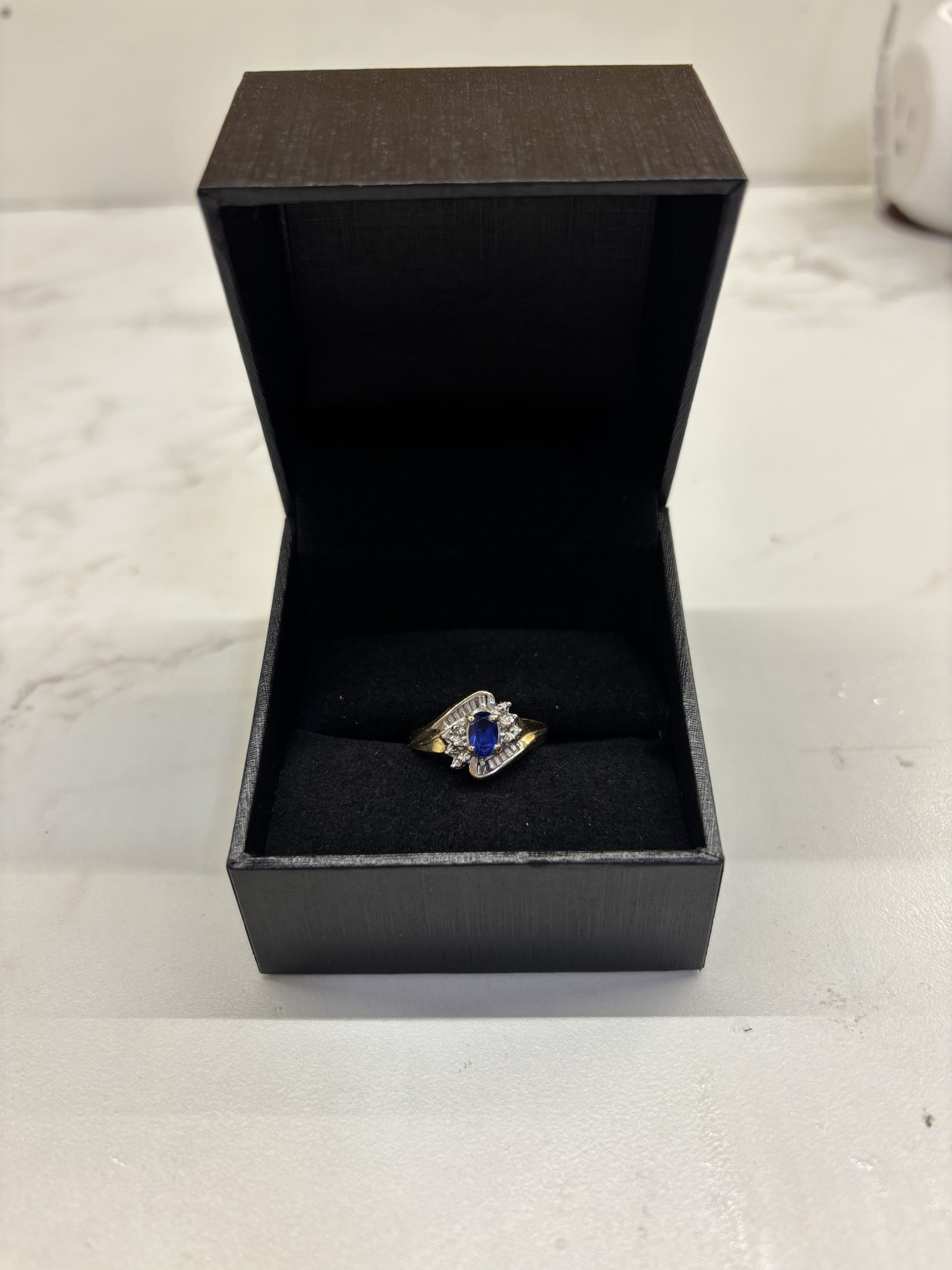 Oval Blue Sapphire and Diamond Bypass Ring in Yellow Gold