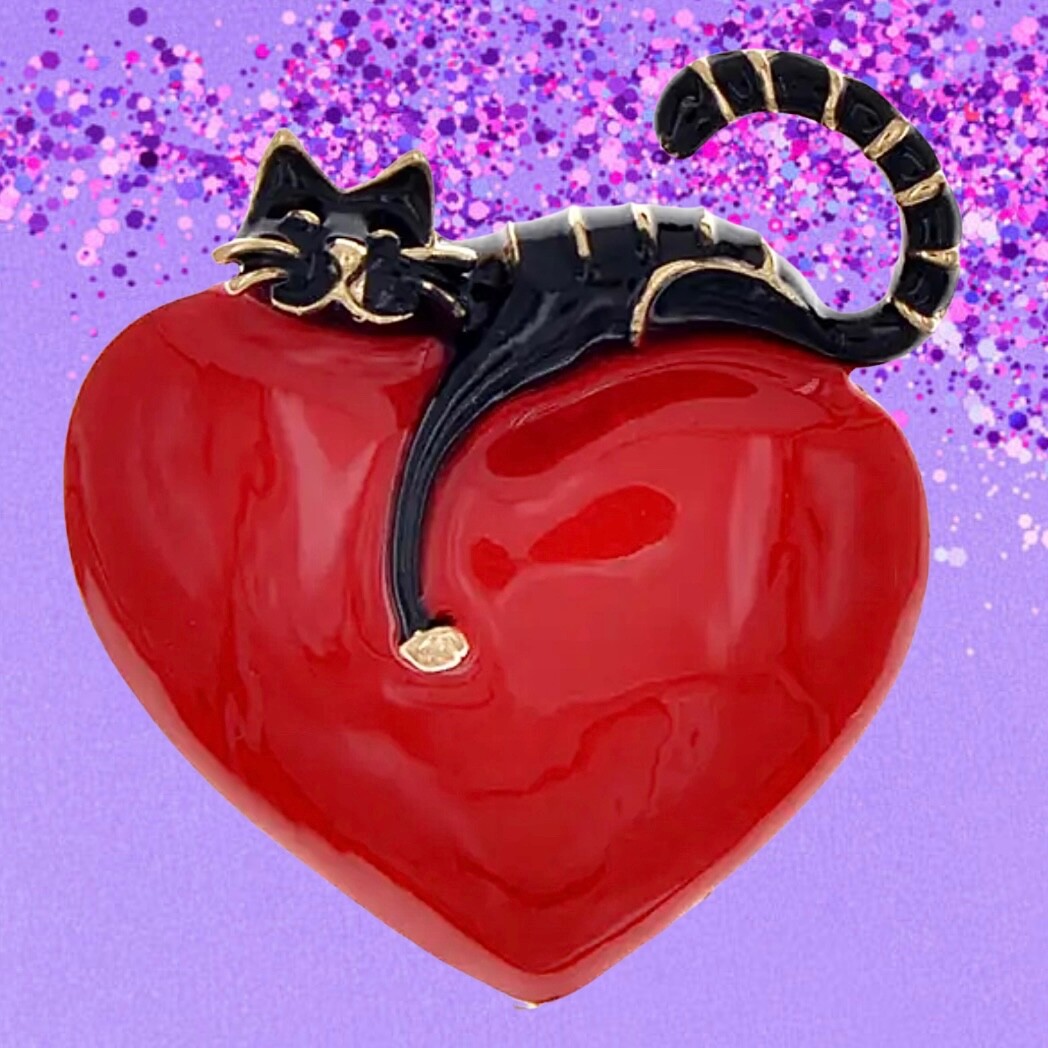 Rich red, shiny heart with comfy cat resting on top. Puffed up. Pin, brooch.