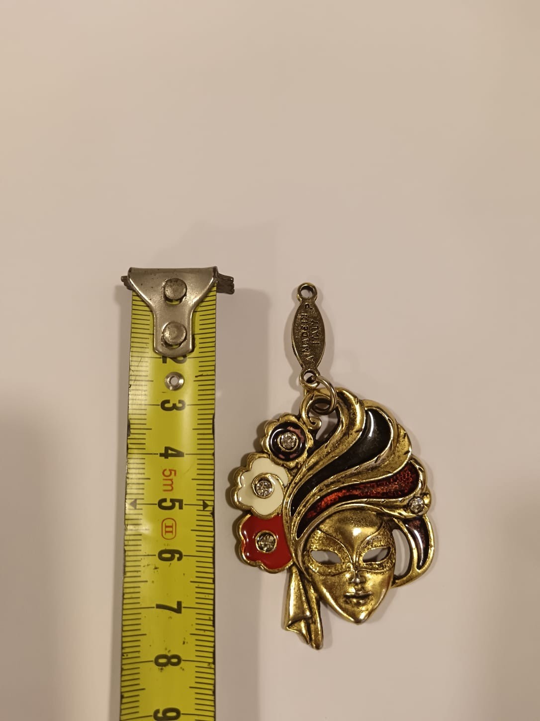 A Detailed Venetian Mask Charm in Gold-Tone Metal with Enamel and Crystal Detail