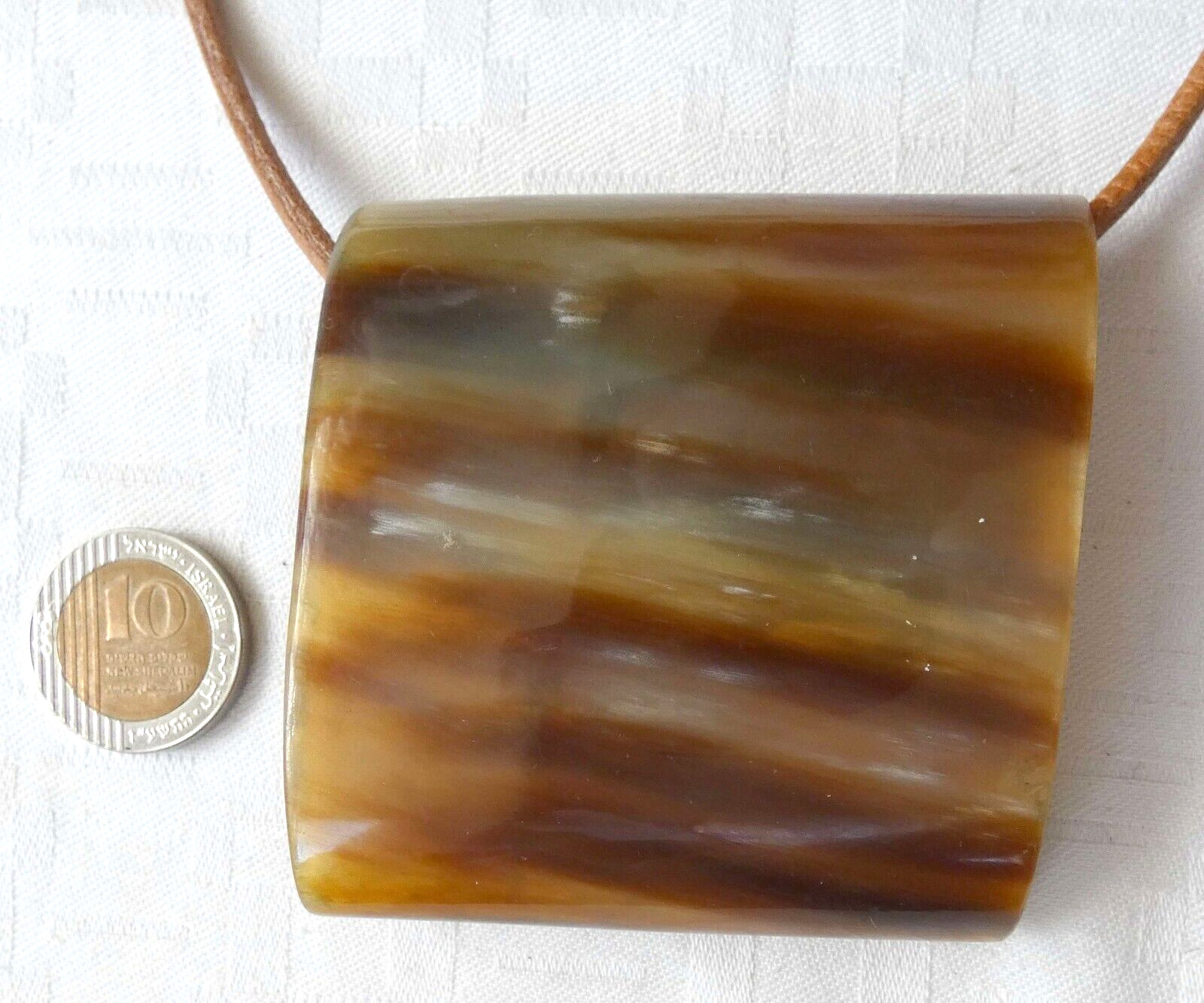 Antique horn necklace with leather cord. Size of pendant: 6.8 x 6.6 cm.