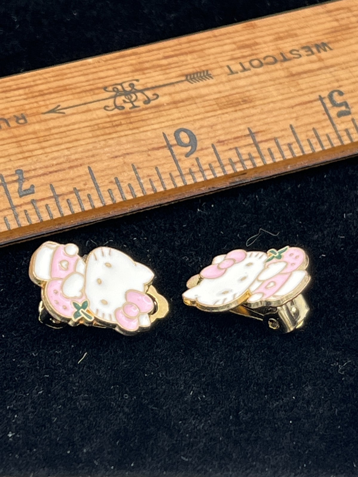 Clip on earrings with Hello Kitty holding a pink strawberry costume jewelry