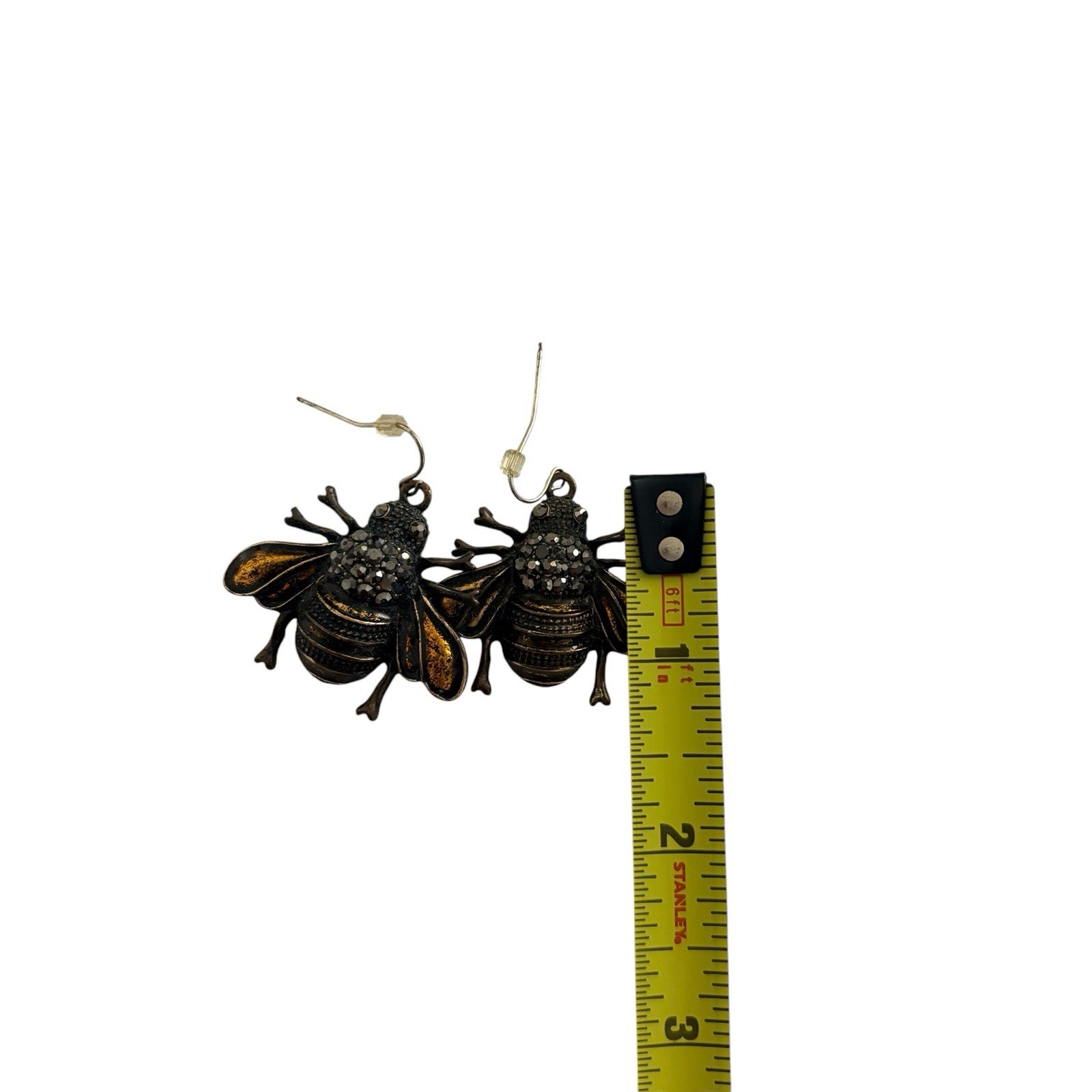 antique brass bee charm earrings on hook wires. Bold bee-shaped dangle earrings.