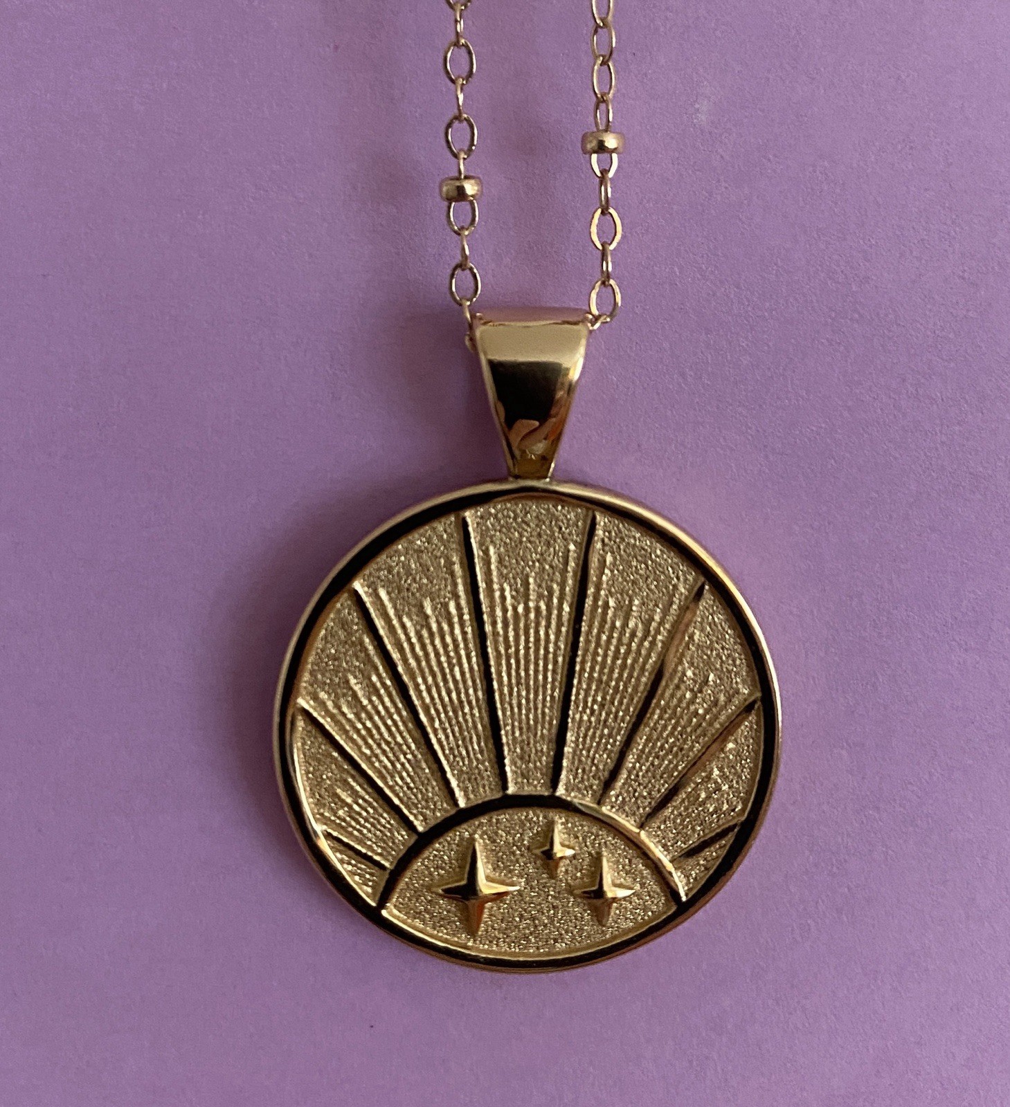 Jane Win Small “Strong” pendant with bead chain.