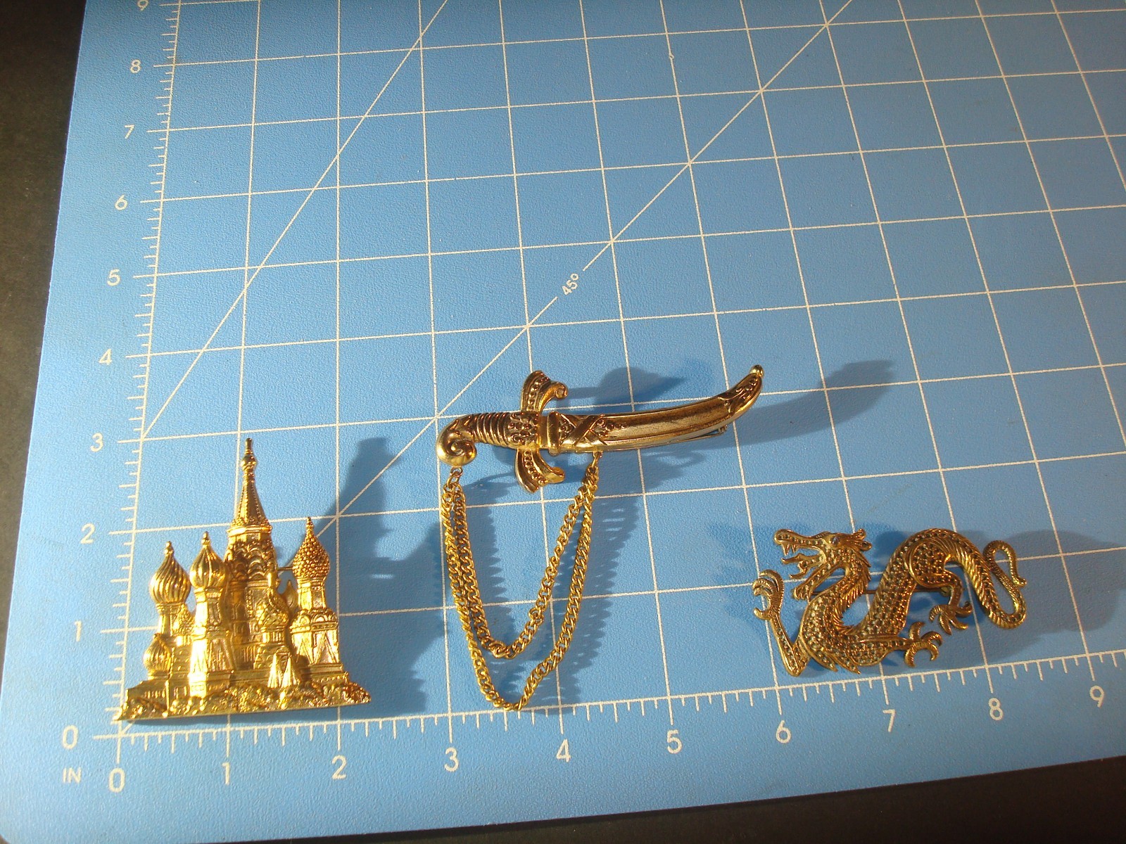 VINTAGE LOT(3) BROOCHES,CHINESE DRAGON,J.J RUSSIAN CATHEDRAL,M/EAST DAGGER PERF.