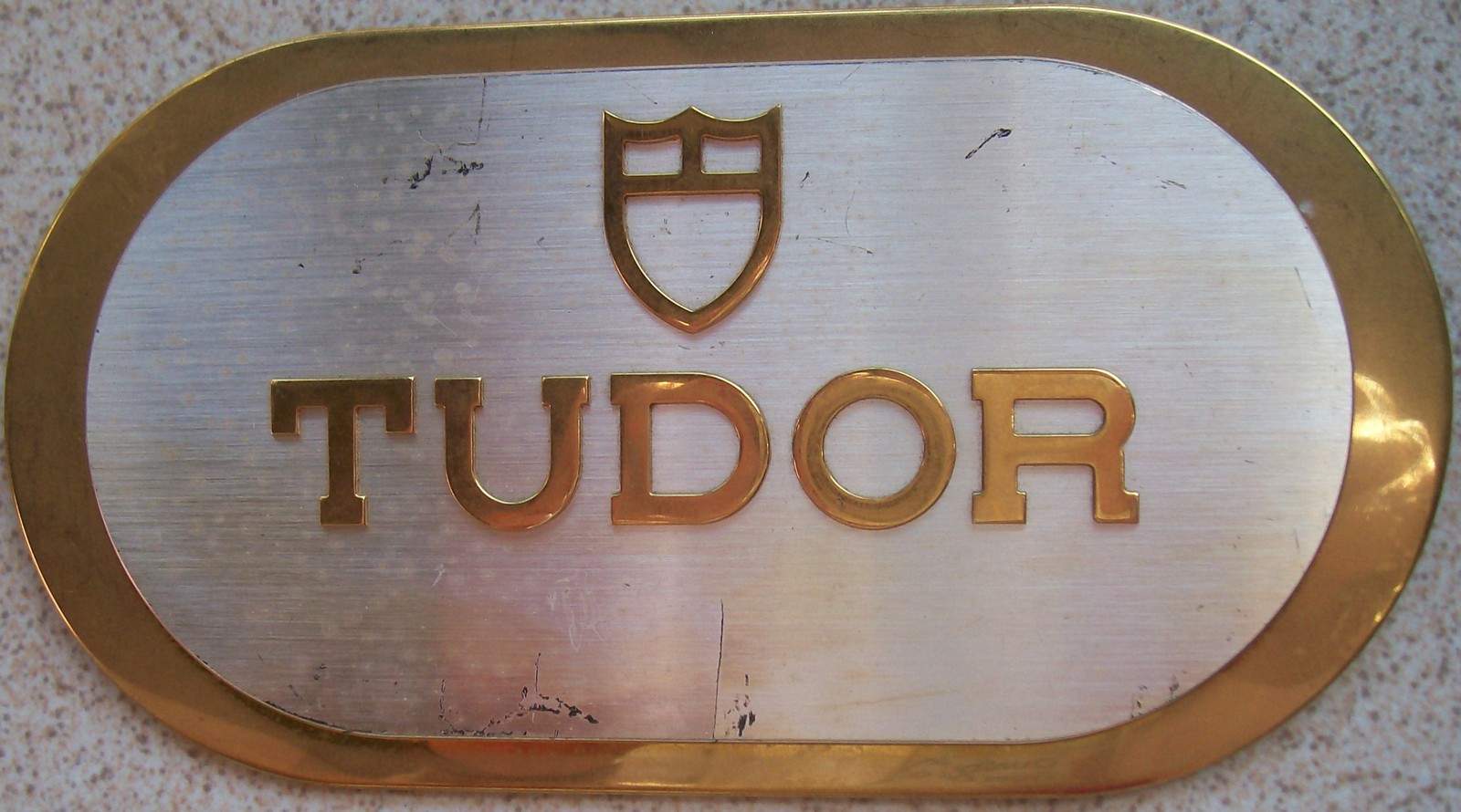 Tudor Swisse Store Advertising 18 cm. x 9,5 cm. aside Bronze and Aluminium