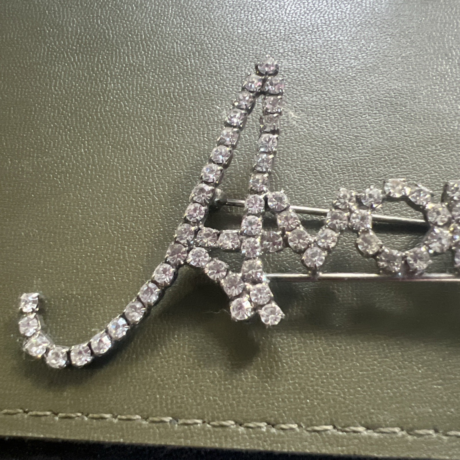 Beautiful Avon Silvertone Logo Pin (letters in Cursive) Approx. 1.75 X 2.5